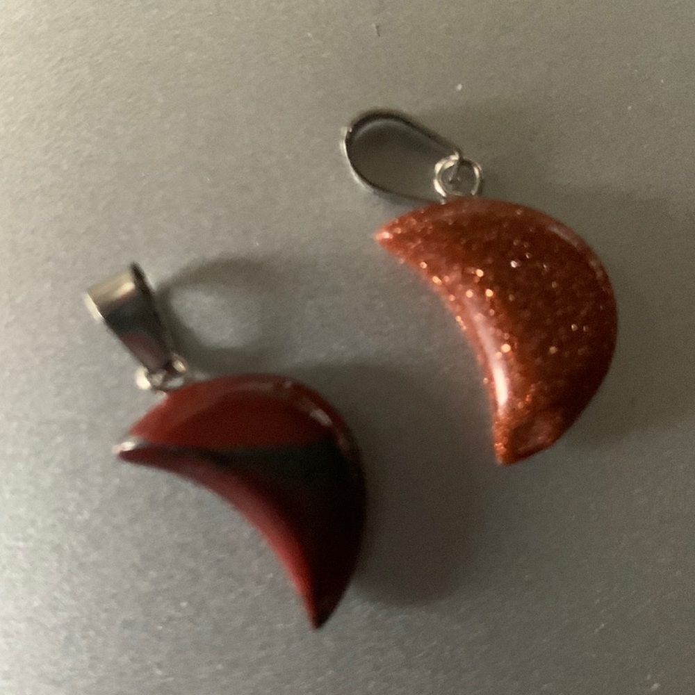 Two tiny moon charms.